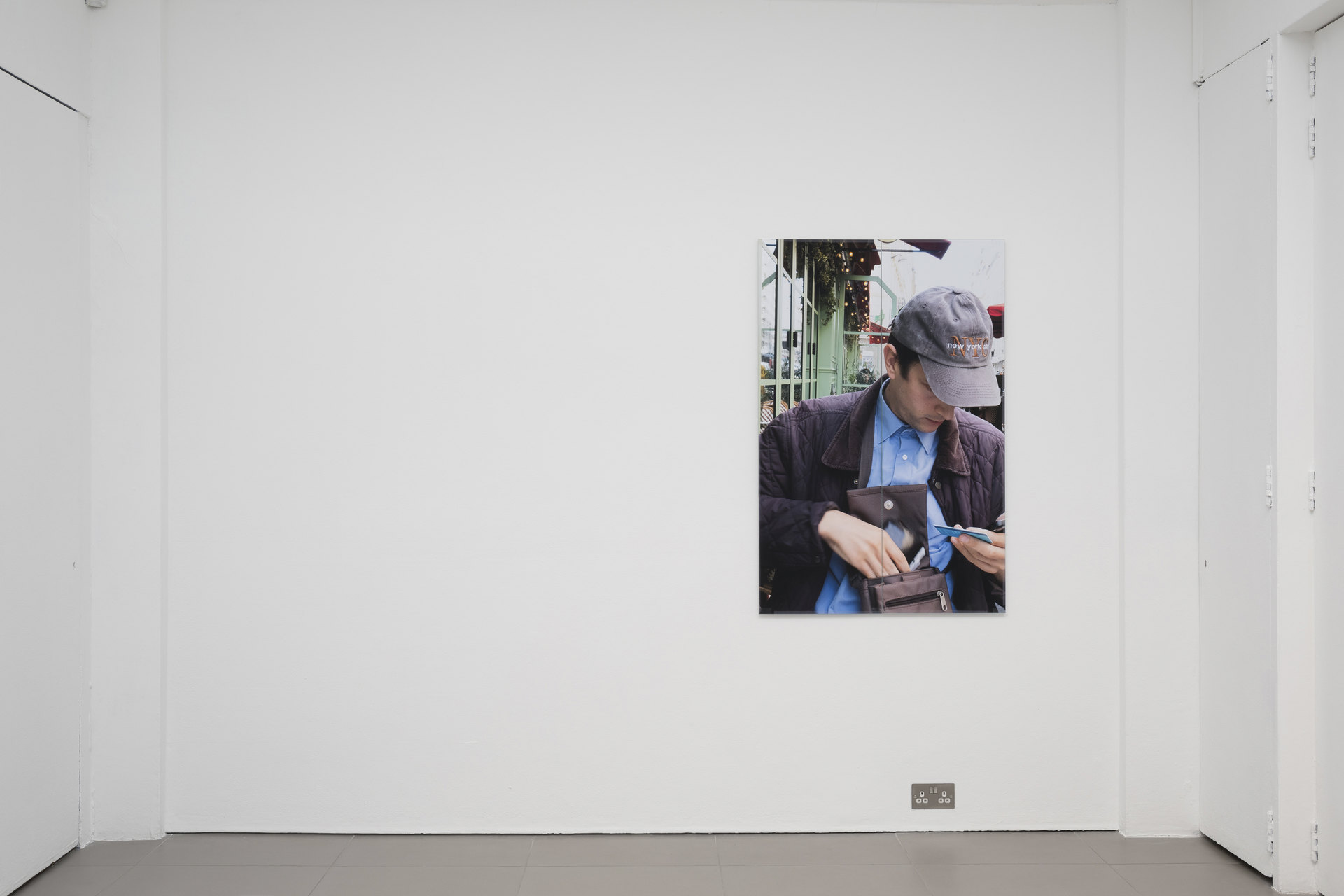 Niklas Taleb, Simon, installation view, 2023, archival pigment print, artist frame; glass, tape