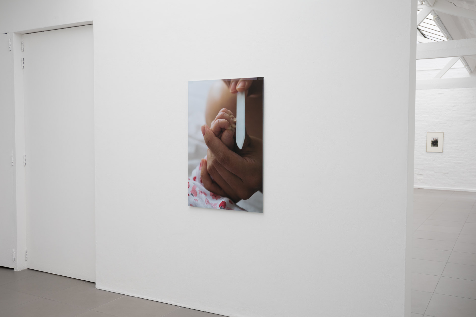 Niklas Taleb, Untitled, installation view, 2023, archival pigment print, artist frame; glass, tape