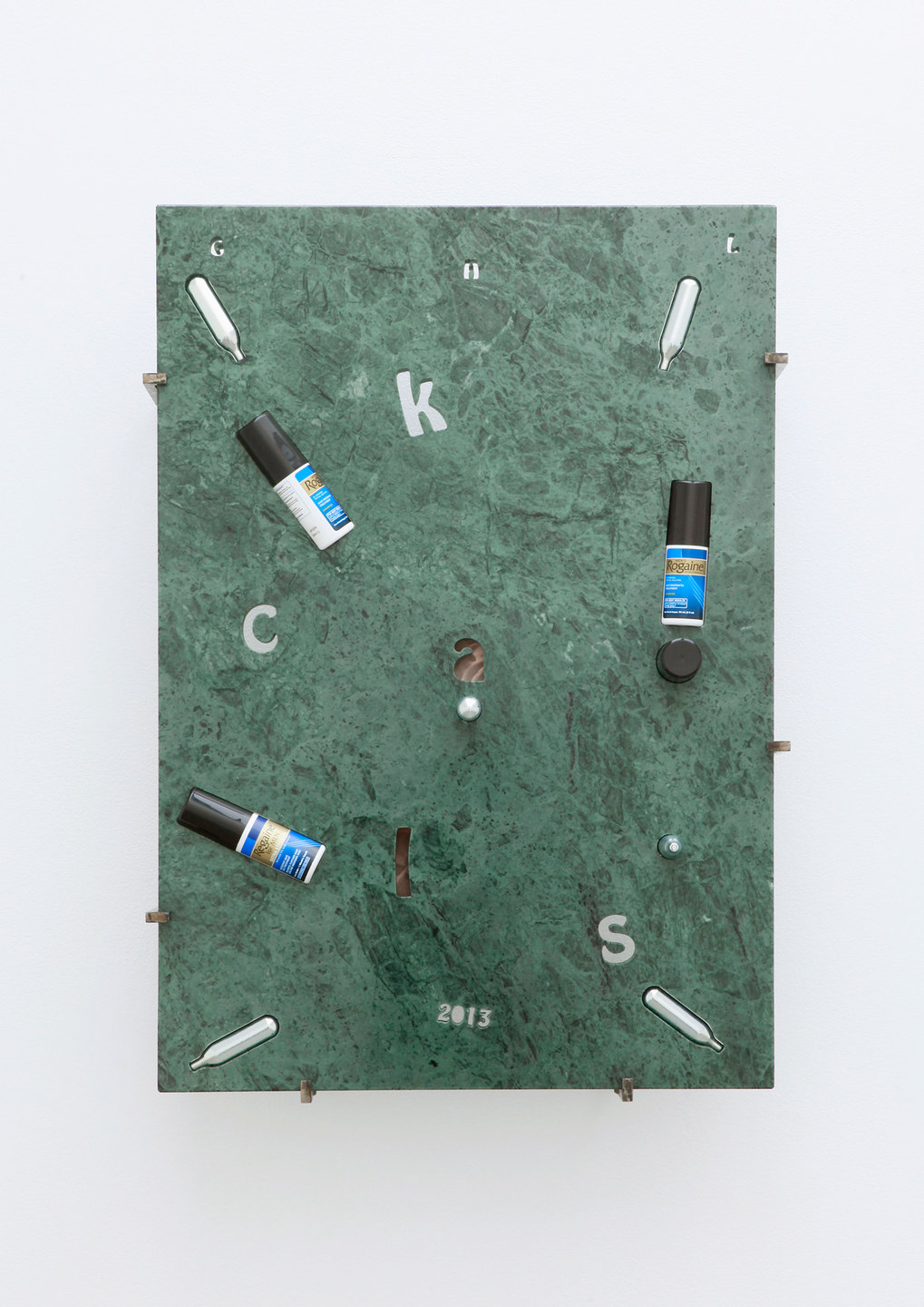 George Henry Longly, 2013: Year of the Snake, 2013, Verde Guatamala marble, whipping cream, chargers (nitrous oxide / laughing gas), Regaine (UK), Rogaine (US), Manifique (gay magazine), steel stand off fixings, 57 x 82 x 18 cm, Cell Project Space