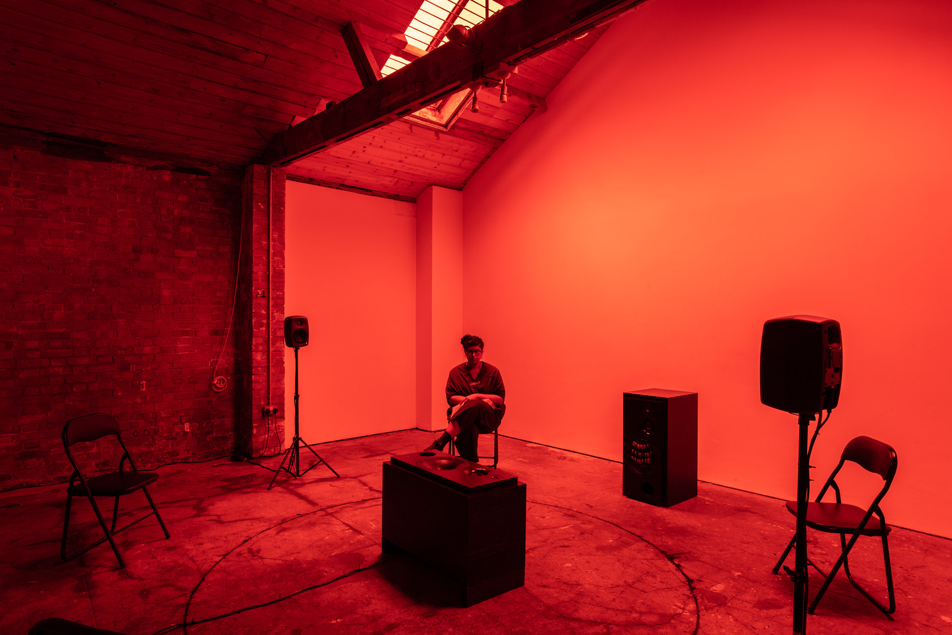 Shenece Oretha, Called To Respond, 2020 Installation View active speakers, chicken bones, cymbals, rehearsal chairs, lighting gel