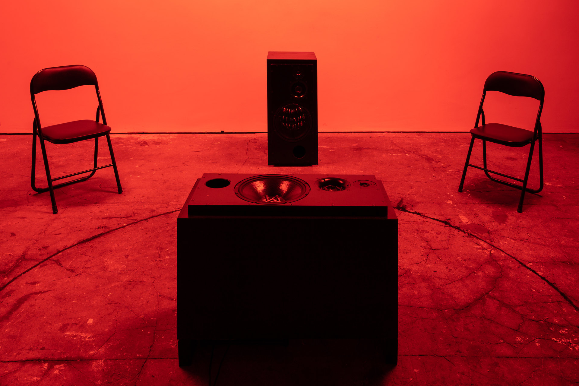 Shenece Oretha Called To Respond, 2020 Installation View active speakers, charcoal, chicken bones, cymbals, rehearsal chairs, lighting gel