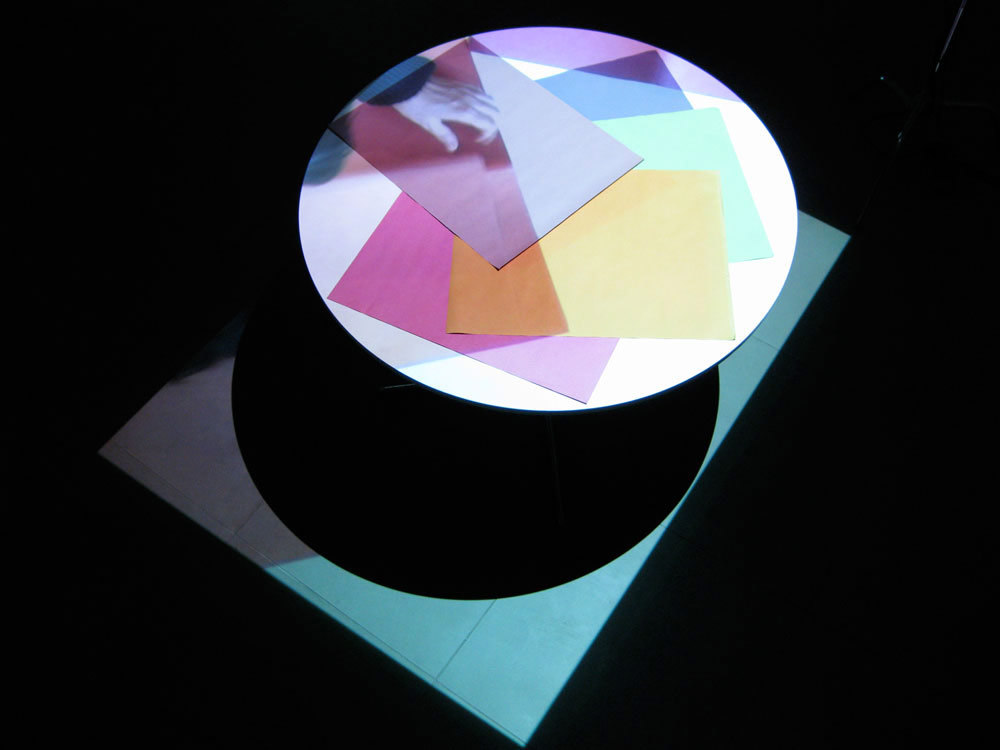 Kim Coleman & Jenny Hogarth 'Sugar Paper', 2008, looped digital film on dvd, table, sugar paper