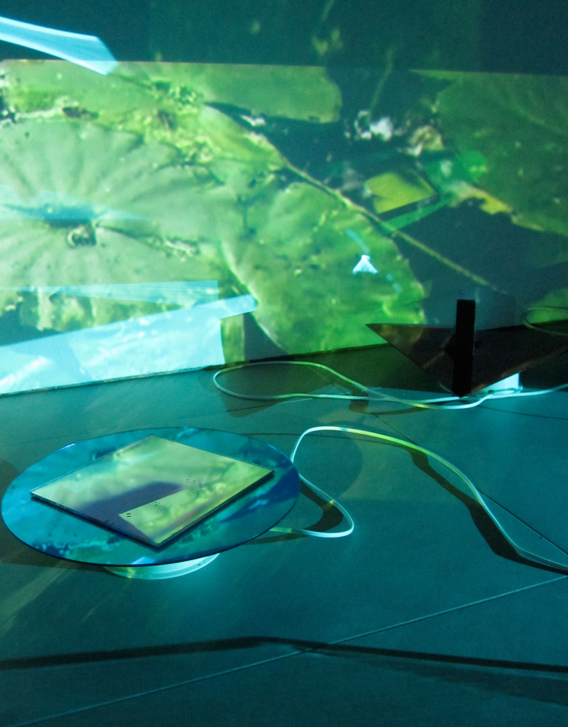 Laura Buckley, Extramundane 2010, Perspex, wood, mirror, motors, music lecterns, 3 video projections, audio (dimensions variable), Cell Project Space