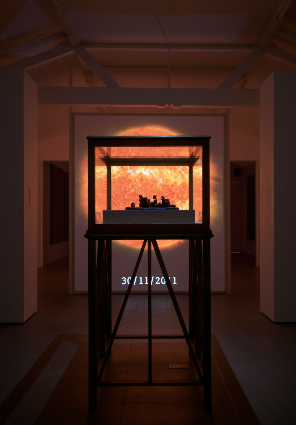 Mark Aerial Waller, SO-LA, 2012 SO-LA, 2012, digital video, duration variable, 'Reconstruction of a 12th century BC Elamite antiquity, Sit Shamsi', 2012, bronze,(w. 53 cm x h. 12 cm x d. 35 cm) with 'Vitrine', 2012, timber, acrylic, linen, (w. 100 cm x h. 165 cm x d. 79 cm)