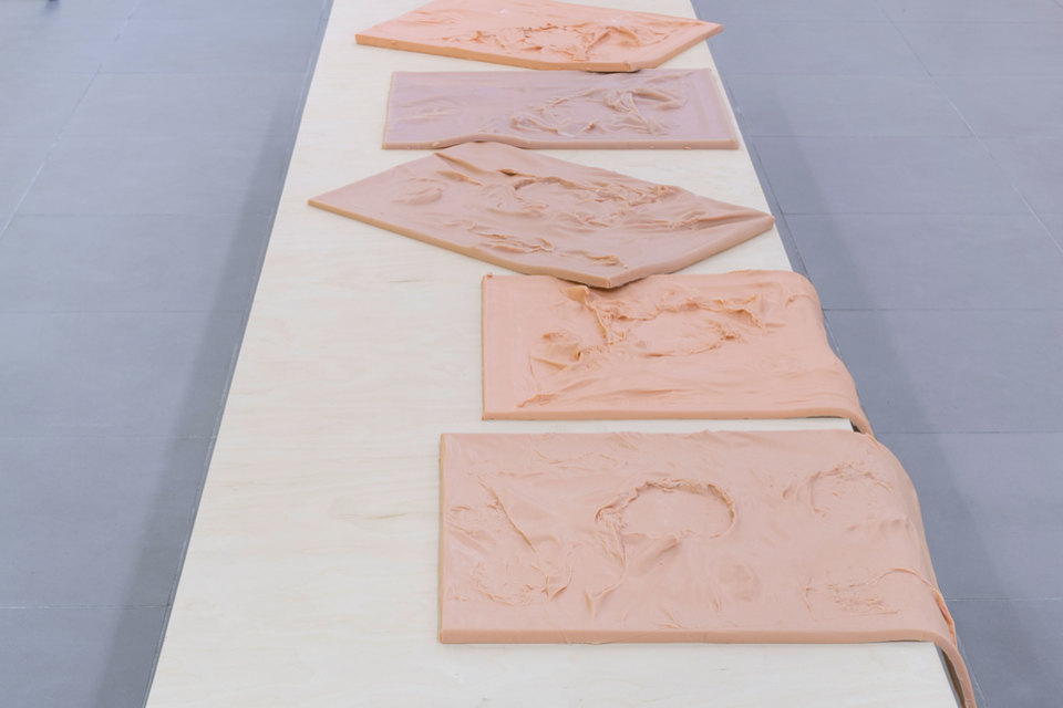 Nikolas Gambaroff, Untitled, 2013, Wooden table with 5 cast silicon works, Table: 77 cm x 381 cm x 55 cm, each silicon work: 61 cm x 46 cm x 3 cm, Cell Project Space