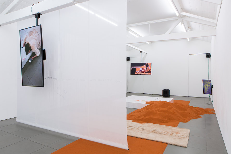 YGRG14X reading with the single hand, 2018, Installation View Video, handmade carpet, Conipur Pro clay dust, handmade curtain, chroma sand Dimensions variable