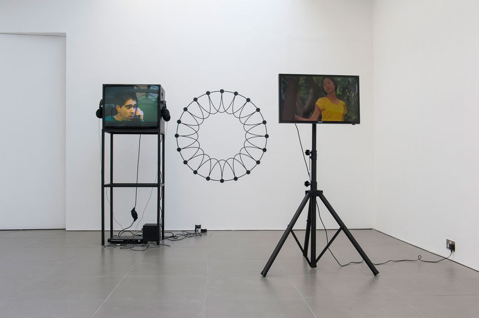 Pre Owned: Looks Good Man, Installation view, 2014 left: Michael Smith, Secret Horror, 1980, colour 4:3 video, duration 13 mins 24 secs, right: Tony Law, Strolling, 2012, single-channel video, duration 3 mins: 24 secs (looped), Cell Project Space