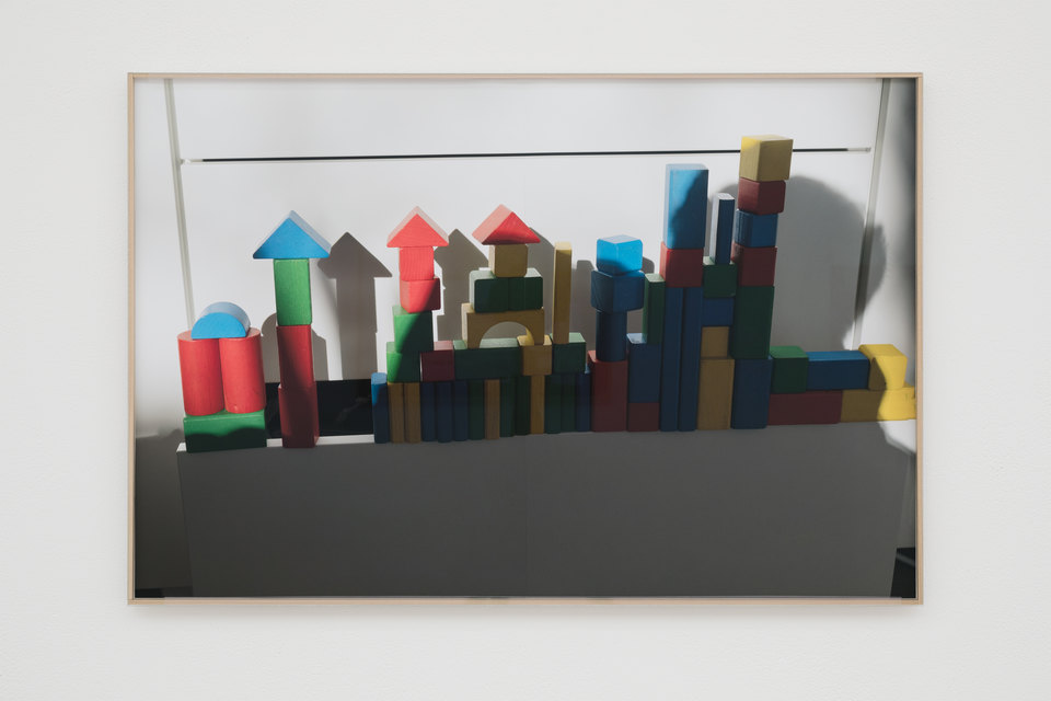 Niklas Taleb, In the City, 2023, archival pigment print, artist frame; glass, tulipwood strips, tape