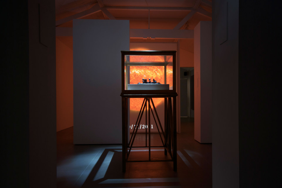 SO-LA, 2012, digital video, duration variable, 'Reconstruction of a 12th century BC Elamite antiquity, Sit Shamsi', 2012, bronze,(w. 53 cm x h. 12 cm x d. 35 cm) with 'Vitrine', 2012, timber, acrylic, linen, (w. 100 cm x h. 165 cm x d. 79 cm)